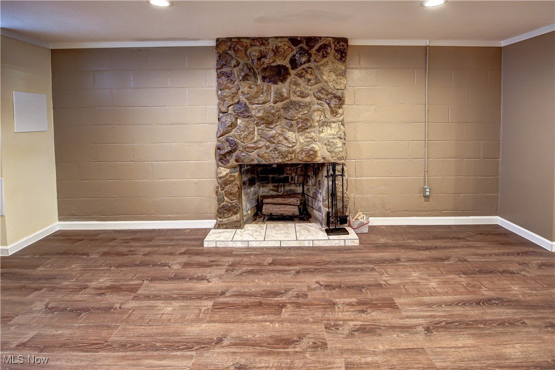 4234 Grafton Road Brunswick, OH 44212 - Photo 24 of 40 Family room featuring ornamental molding, hardwood / wood-style floors, and a fireplace