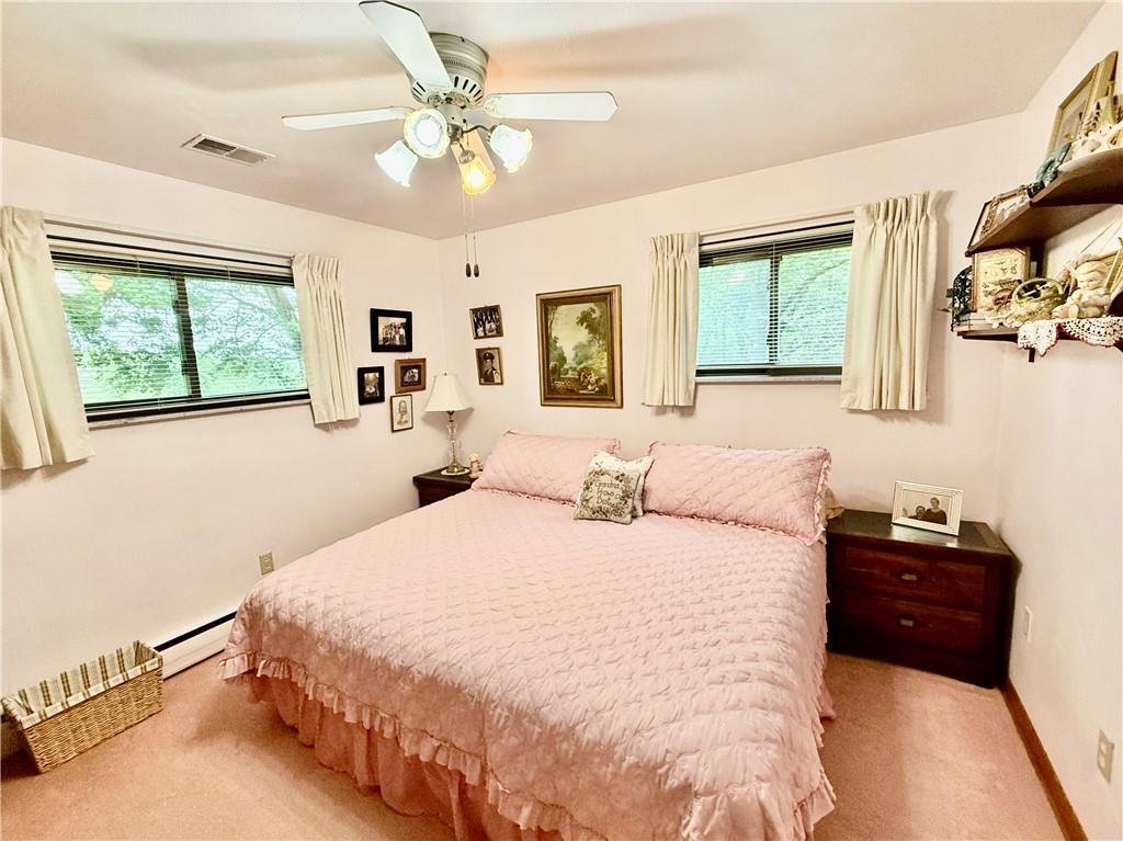 320 Saxonburg Road Butler, PA 16002 - Photo 18 of 36 a bedroom with a large bed and a chandelier fan