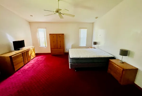 a bedroom with a bed and a flat screen tv