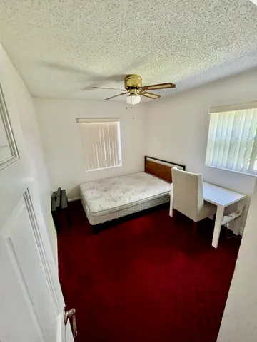 a bedroom with a bed and a table in it