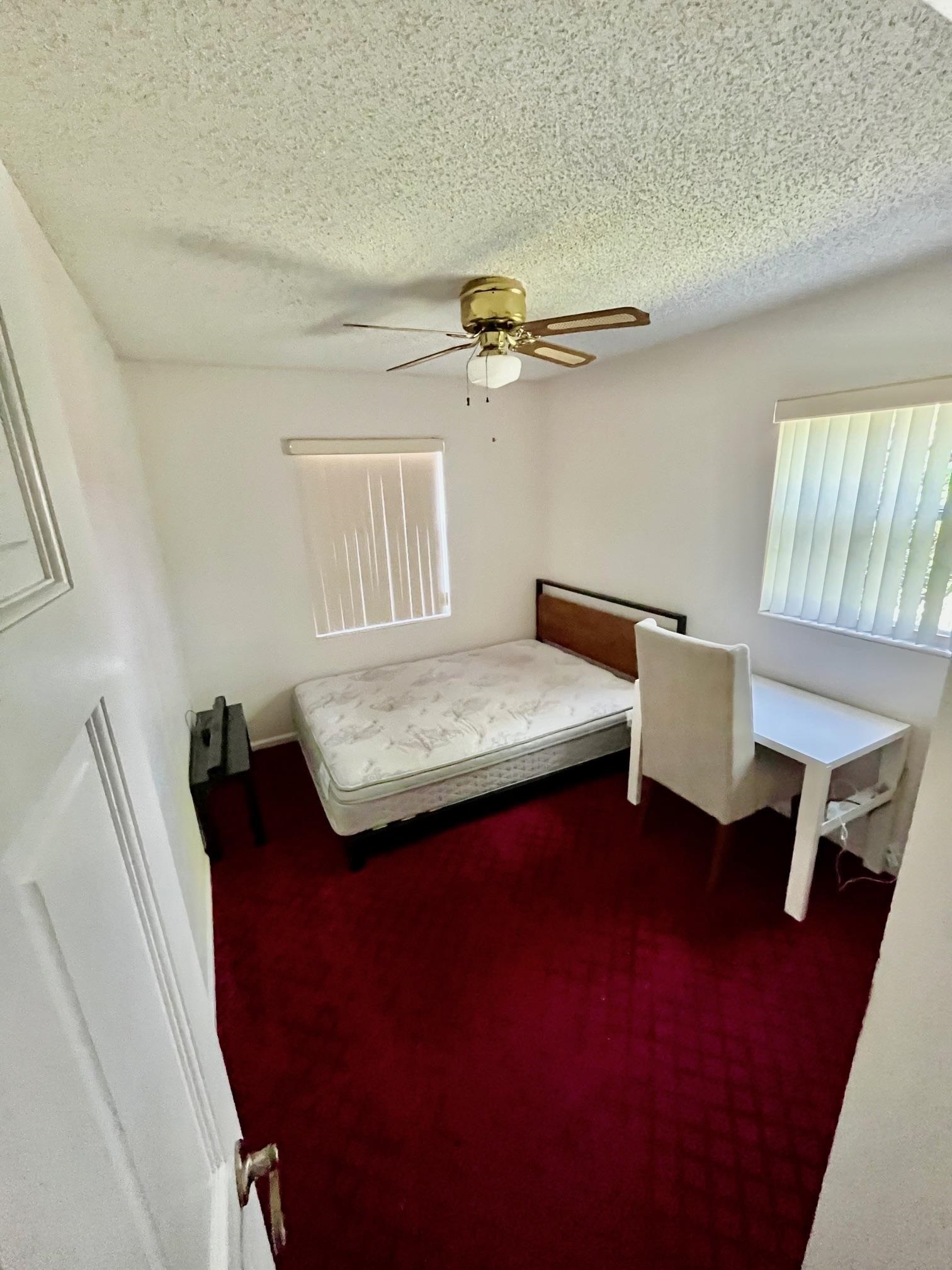 60 Palmer Street St. Augustine, FL 32084 - Photo 14 of 26 a bedroom with a bed and a table in it