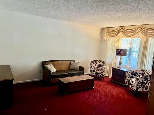 a bedroom with furniture and a window