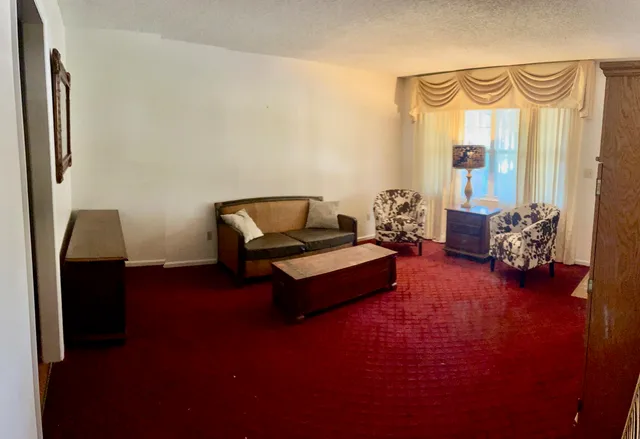 a living room with furniture and a chandelier
