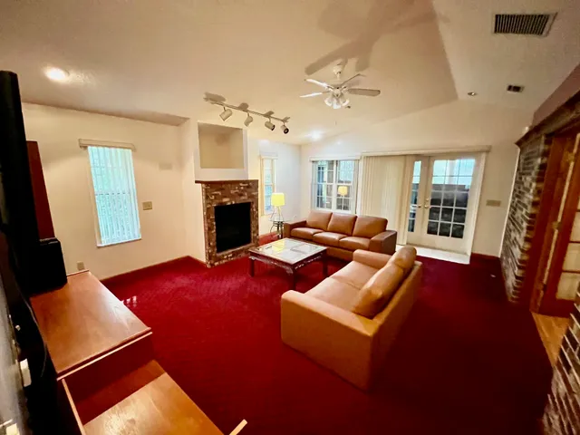 a living room with furniture fireplace and a flat screen tv