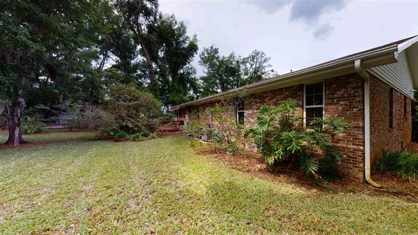 a view of a house with a yard and sitting area