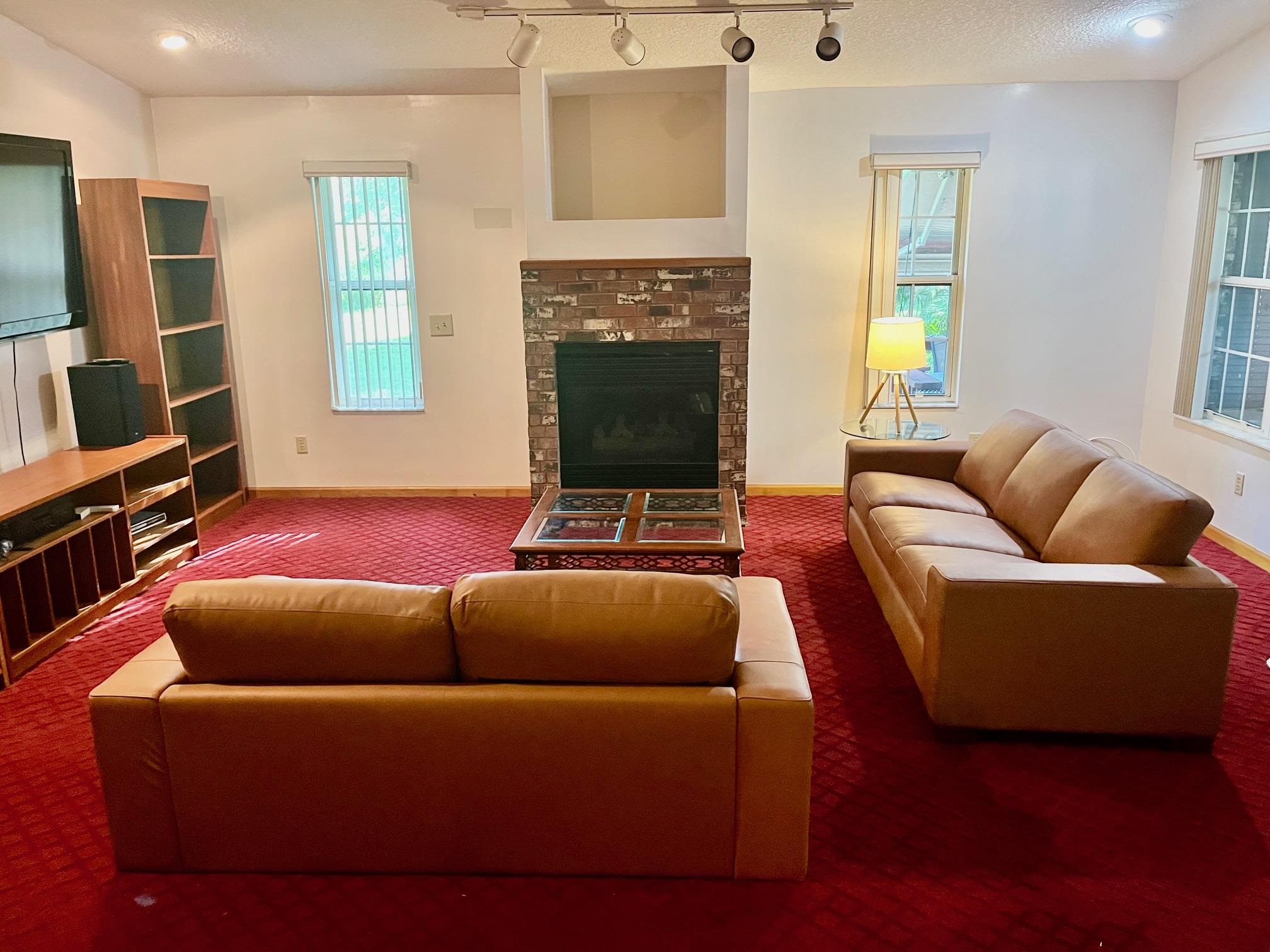 60 Palmer Street St. Augustine, FL 32084 - Photo 4 of 26 a living room with furniture a fireplace and a flat screen tv