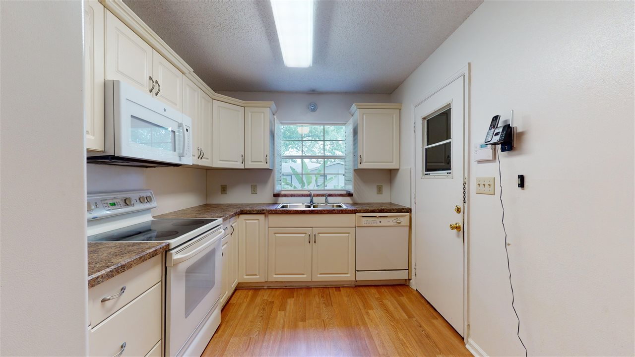 60 Palmer Street St. Augustine, FL 32084 - Photo 6 of 26 a kitchen with stainless steel appliances granite countertop a sink a stove a refrigerator and cabinets