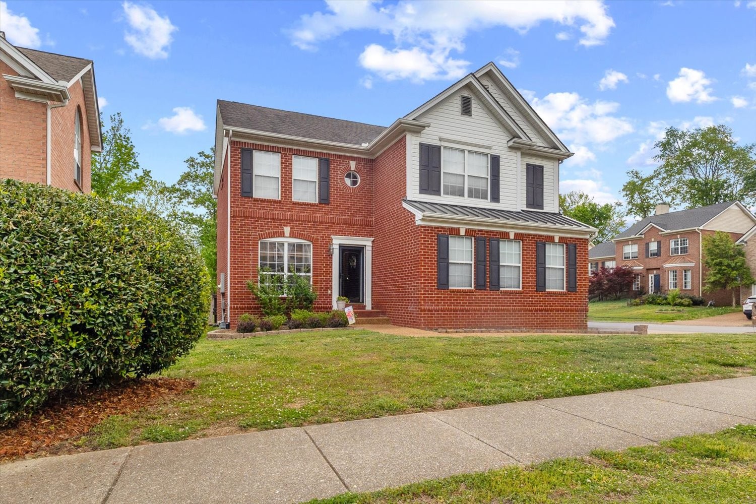 406 Orchid Road Franklin, TN 37064 - Photo 2 of 52 a front view of a house with a yard and trees