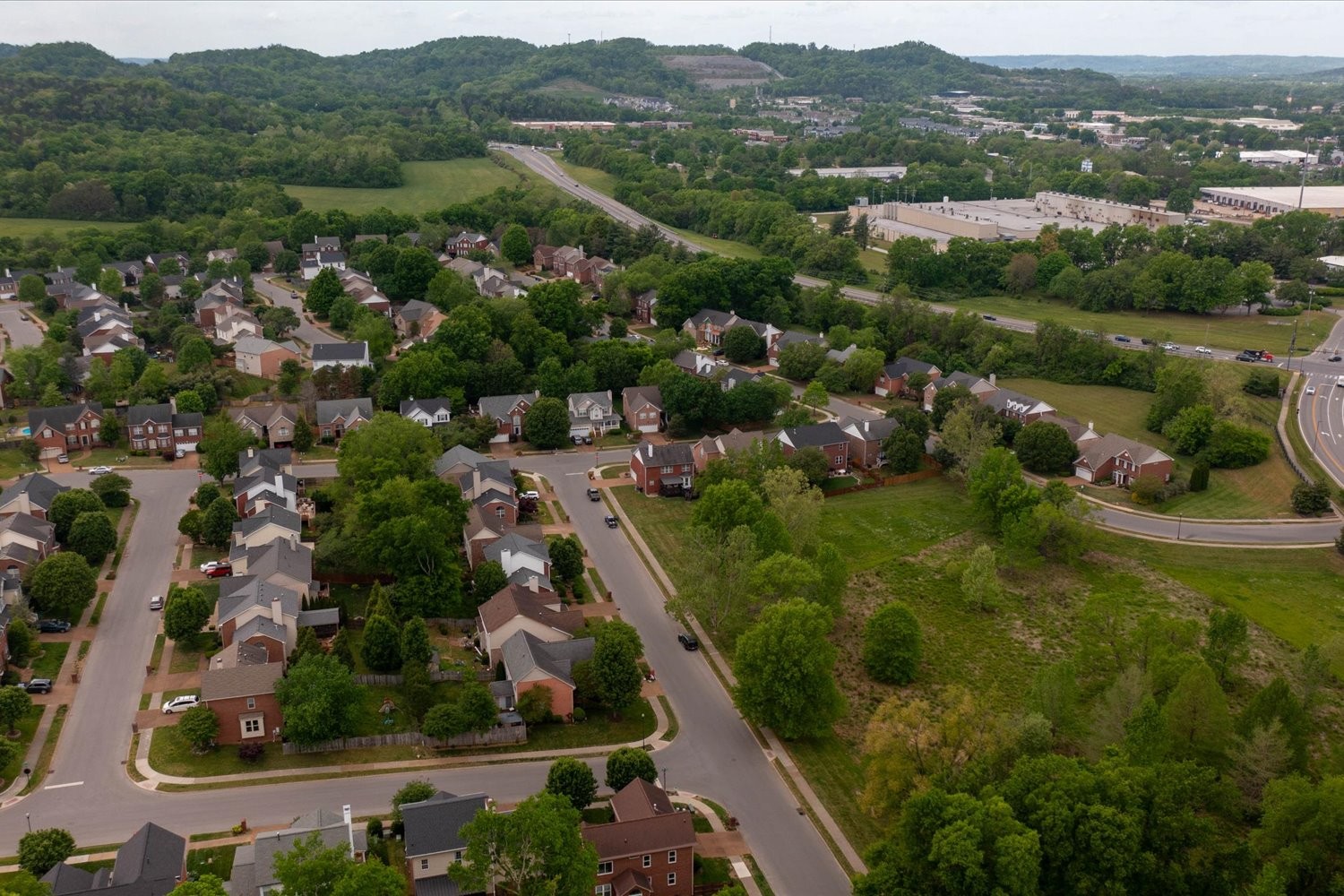 406 Orchid Road Franklin, TN 37064 - Photo 48 of 52 an aerial view of green landscape with trees houses and mountain view