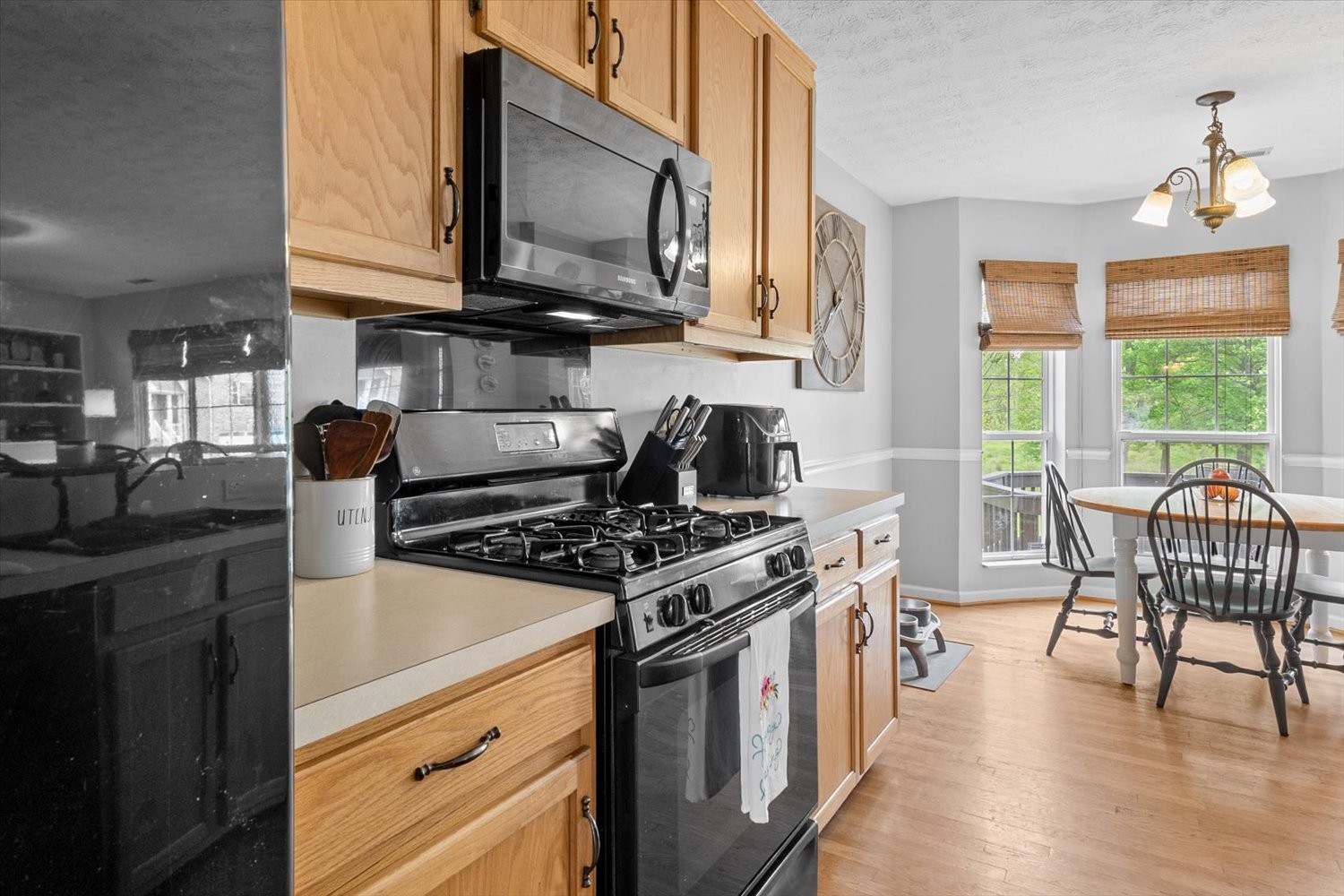 406 Orchid Road Franklin, TN 37064 - Photo 7 of 52 a kitchen with stainless steel appliances granite countertop a stove top oven a sink dishwasher a dining table and chairs with wooden floor