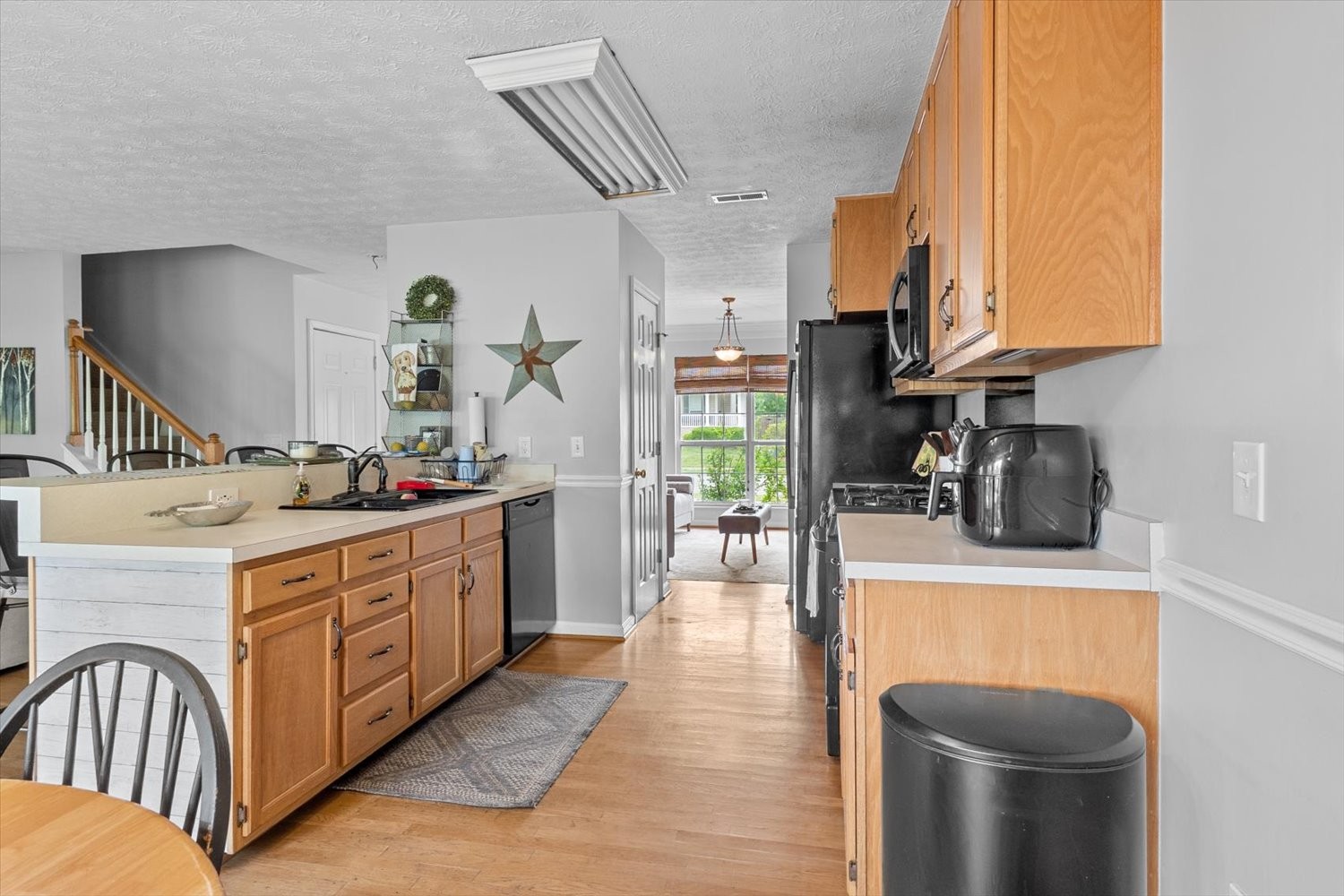 406 Orchid Road Franklin, TN 37064 - Photo 8 of 52 a kitchen with stainless steel appliances granite countertop a sink a stove and a wooden floors