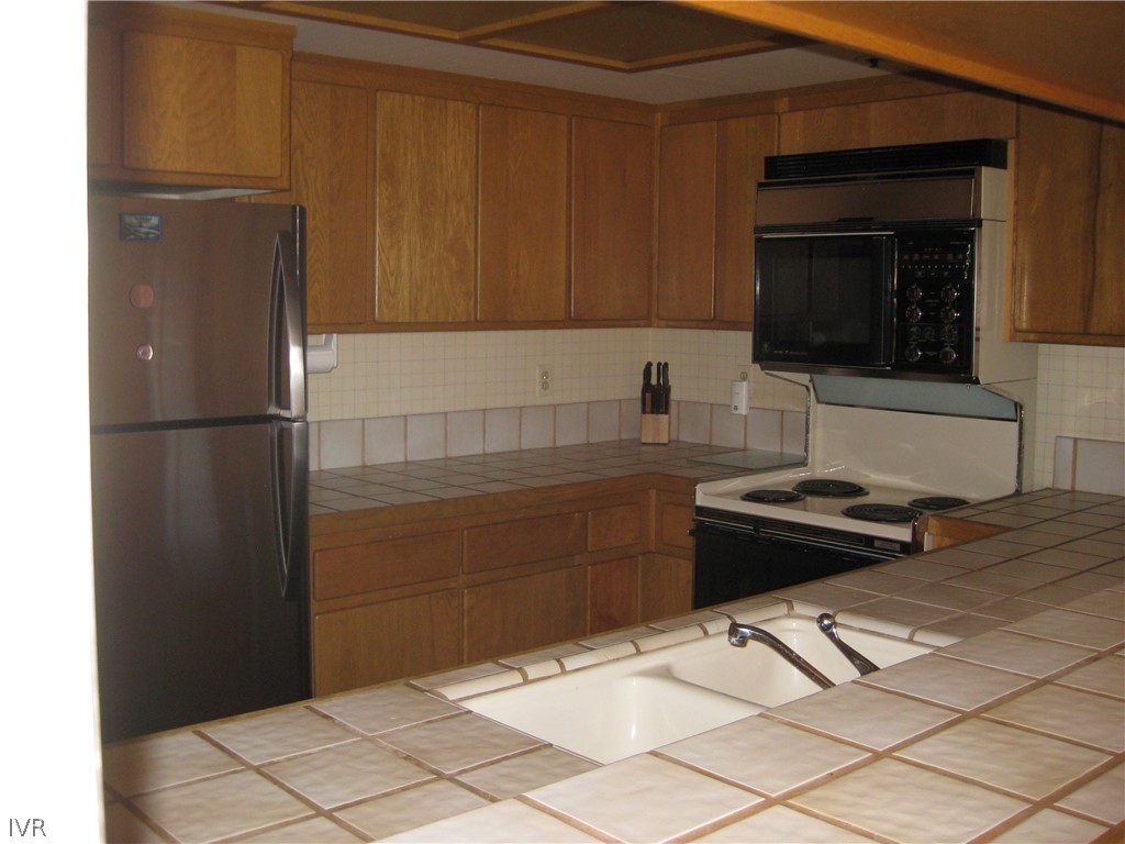 335 Ski Way, Unit 314 Incline Village, NV 89451 - Photo 15 of 15 a kitchen with a refrigerator and a stove top oven