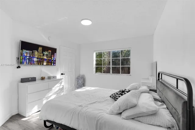 a large white bed in a white room