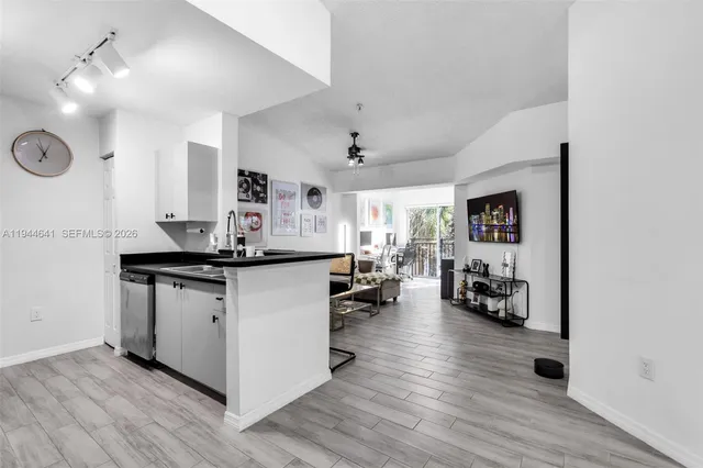 a kitchen with stainless steel appliances granite countertop a stove and a refrigerator
