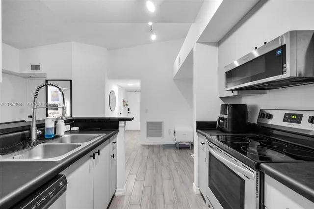 a kitchen that has a sink and a stove