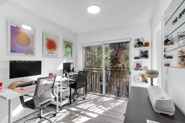 a view of a livingroom with furniture and a flat screen tv