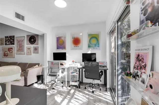 a view of a workspace with furniture and a window