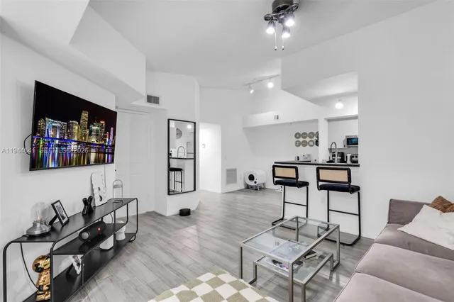 a living room with furniture and wooden floor