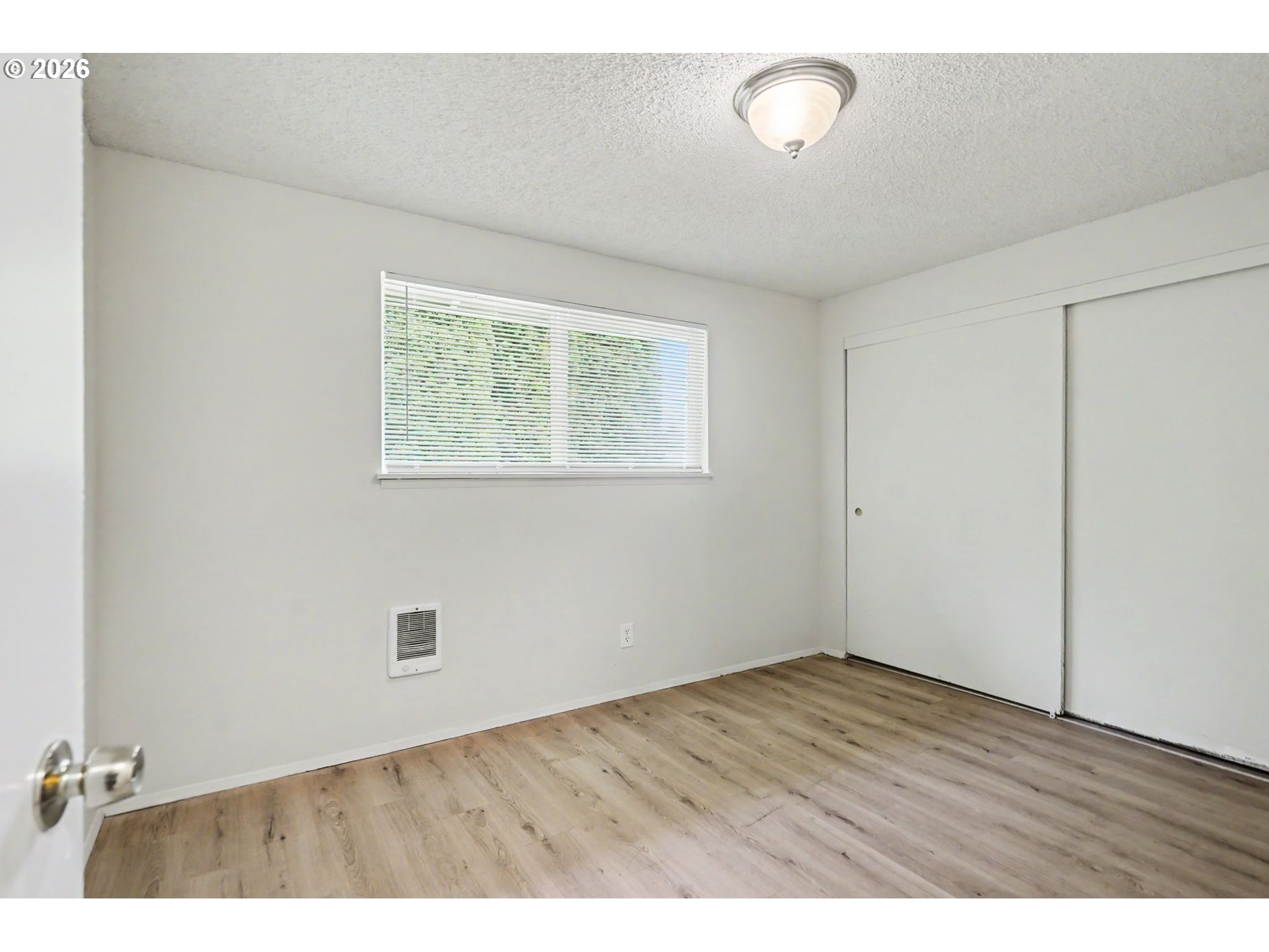 777 Boone Road Southeast, Unit 12 Salem, OR 97302 - Photo 12 of 16 an empty room with wooden floor and windows