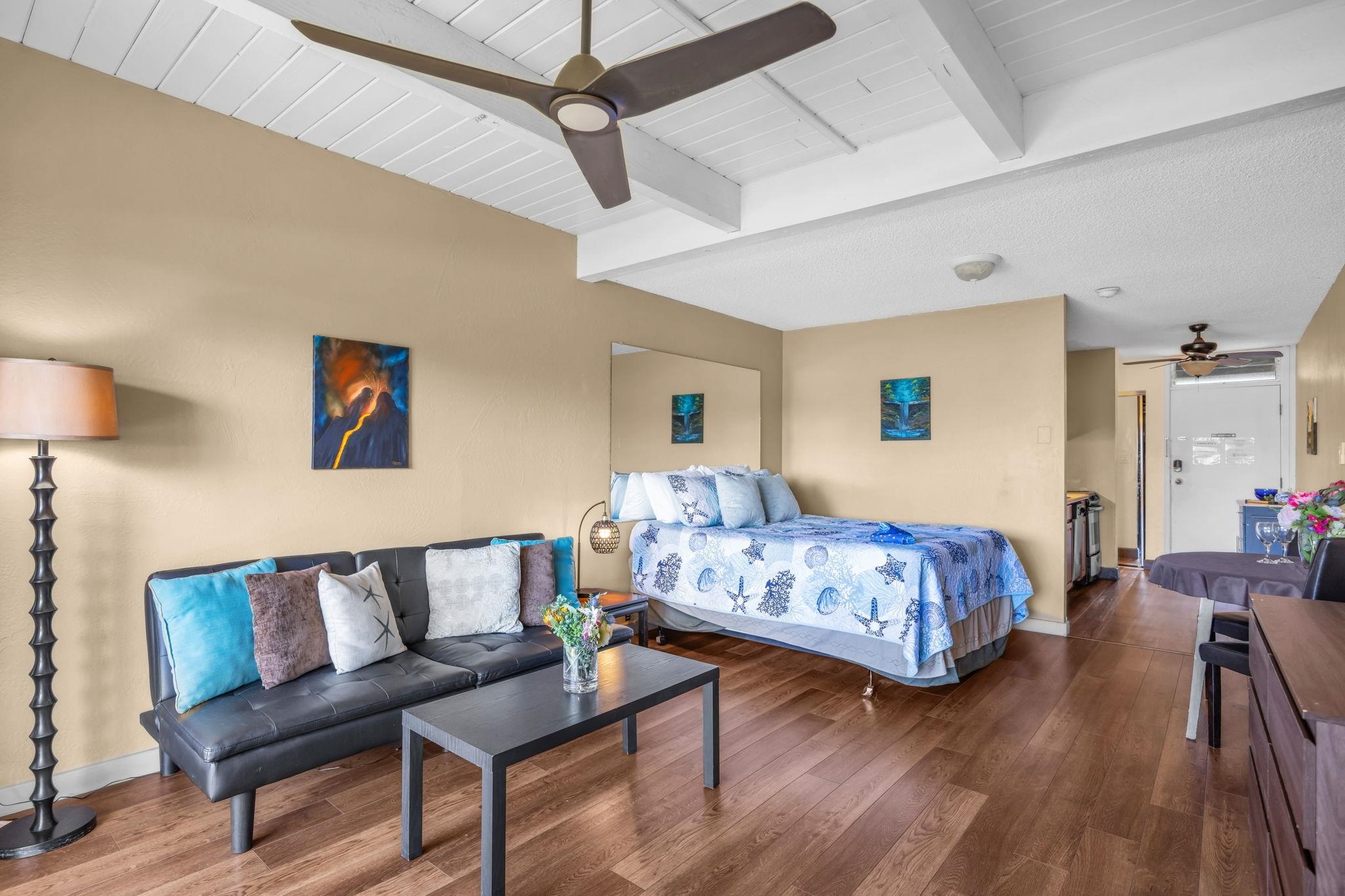 715 South Kihei Road, Unit 107 Kihei, HI 96753 - Photo 7 of 29 a bedroom with a bed and wooden floor