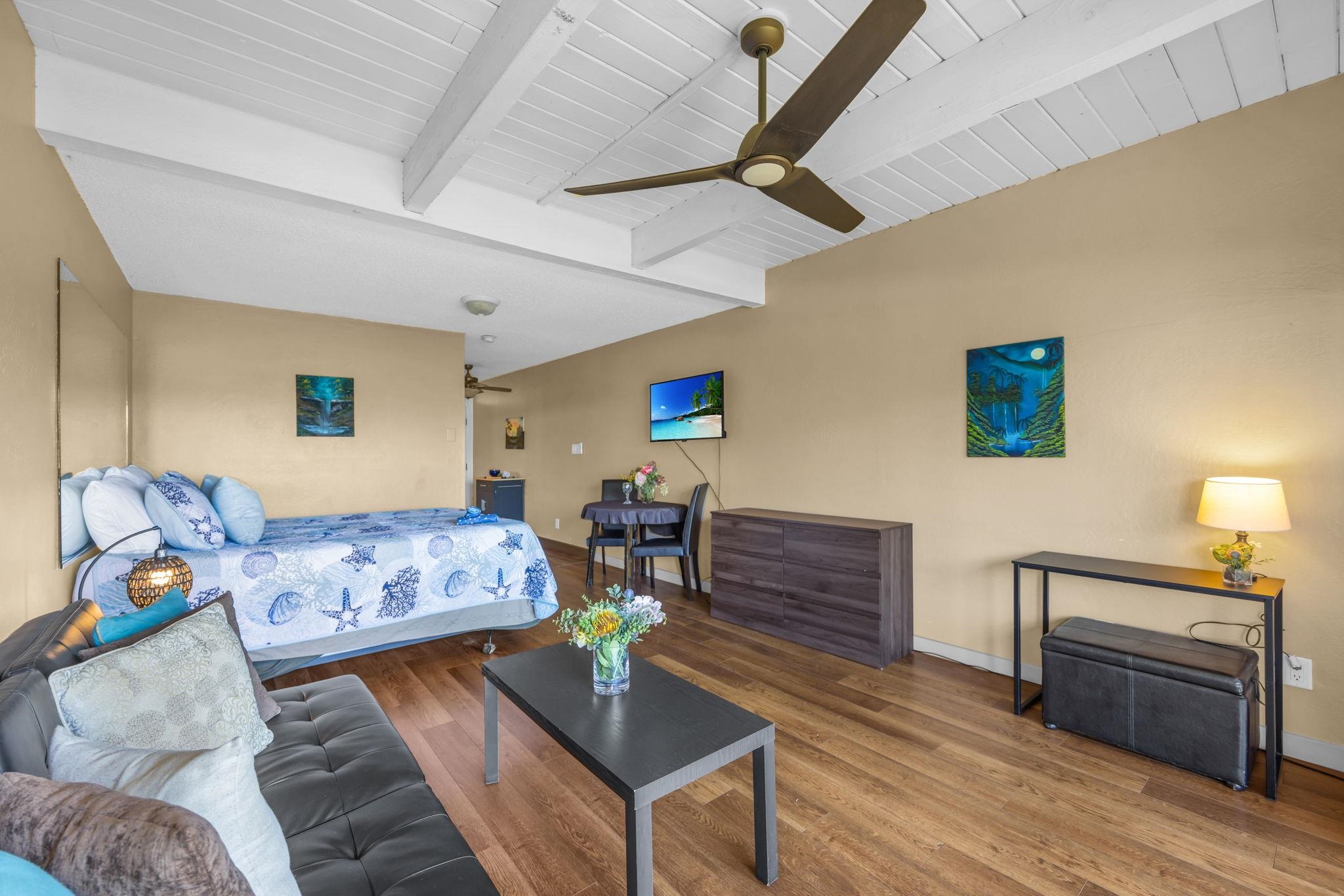 715 South Kihei Road, Unit 107 Kihei, HI 96753 - Photo 8 of 29 a bedroom with furniture and a wooden floor