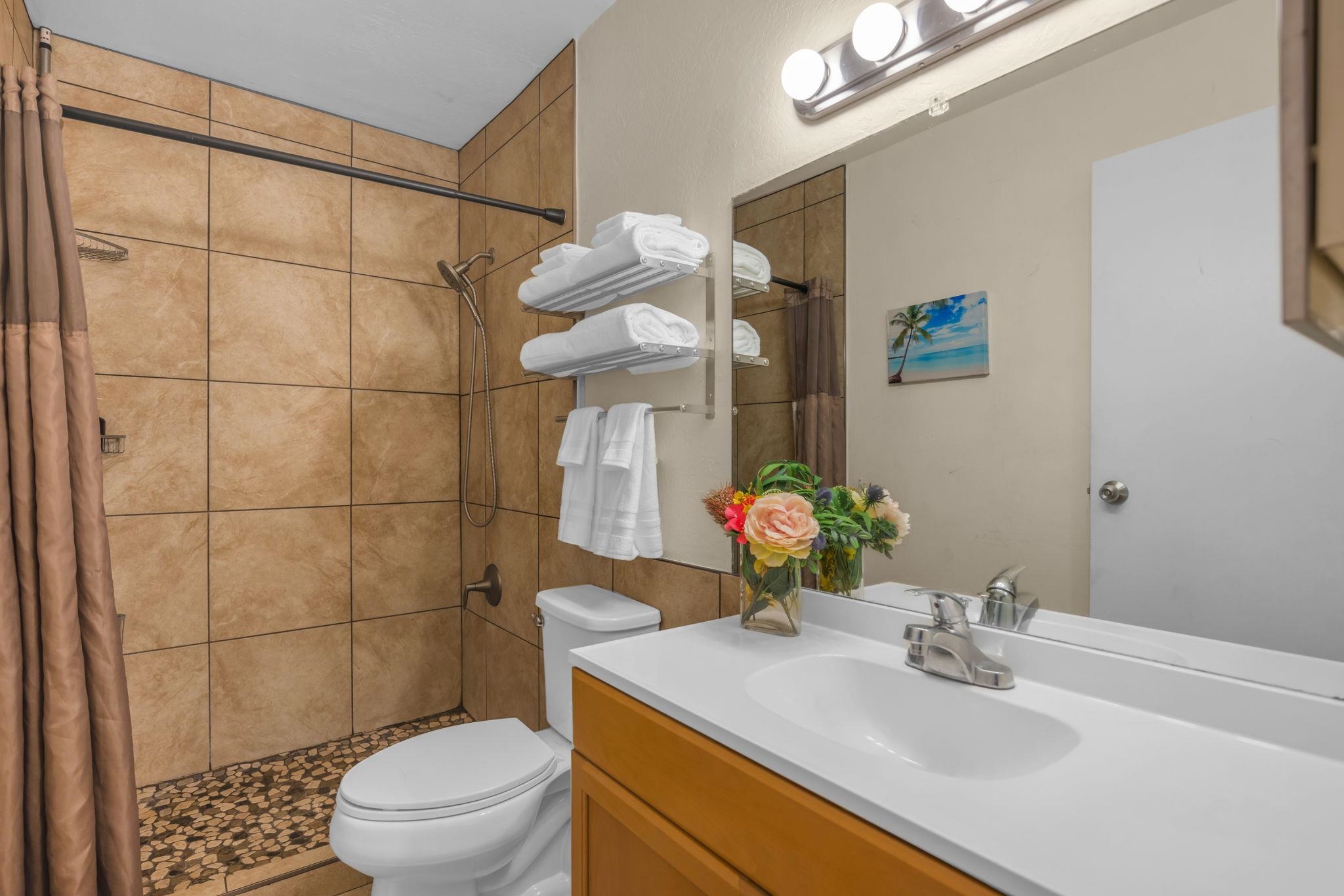 715 South Kihei Road, Unit 107 Kihei, HI 96753 - Photo 10 of 29 a bathroom with a sink toilet vanity and shower