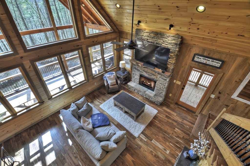 705 George Curtis Road Blue Ridge, GA 30513 - Photo 3 of 49 a living room with furniture and a floor to ceiling window