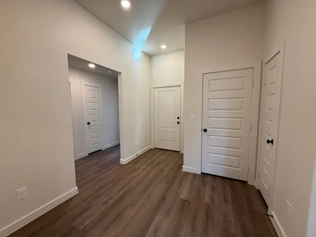 a kitchen with stainless steel appliances granite countertop a sink and a stove top oven with wooden floor