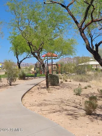 a view of a yard with yellow house