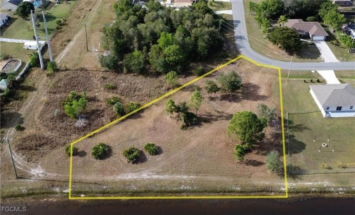 145 Zenith Circle Fort Myers, FL 33913 - Photo 3 of 9 an aerial view of a house with a yard and lake view