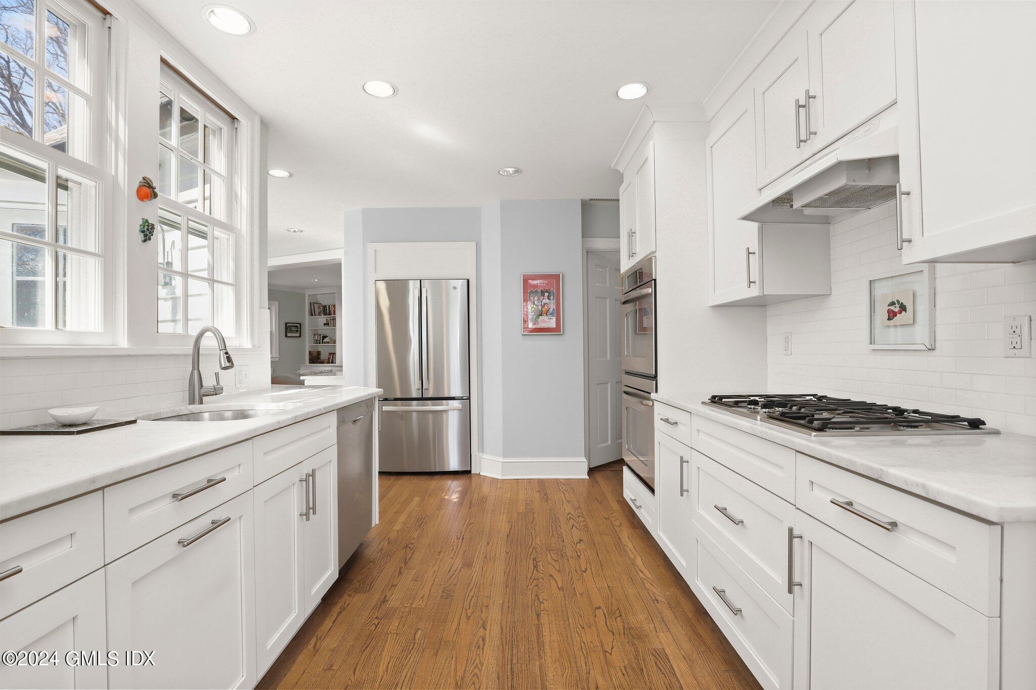 174 Cat Rock Road Cos Cob, CT 06807 - Photo 14 of 45 a kitchen with stainless steel appliances granite countertop a sink stove and refrigerator