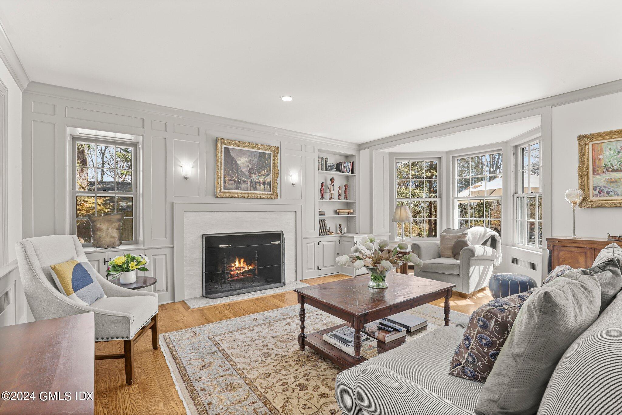 174 Cat Rock Road Cos Cob, CT 06807 - Photo 8 of 45 a living room with furniture and a fireplace
