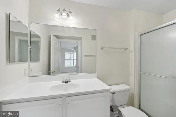 a bathroom with a sink toilet and mirror