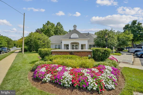 a front view of a house with a yard and fountain