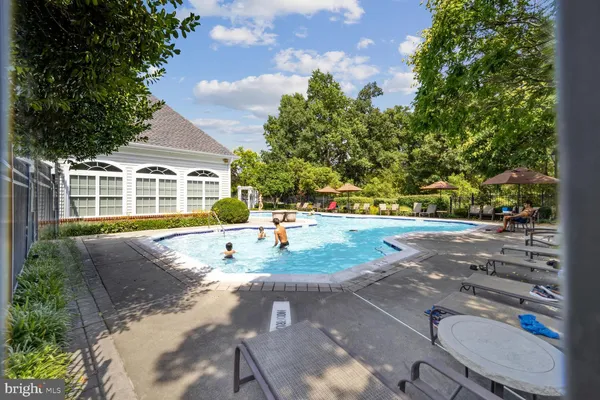 a view of a swimming pool with an outdoor space and seating area