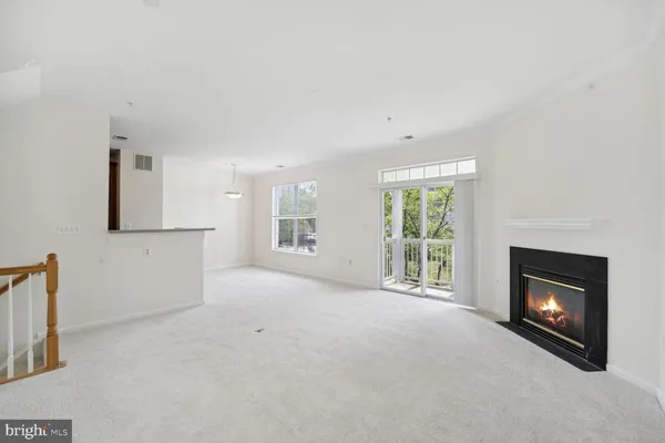 a view of empty room with a fireplace