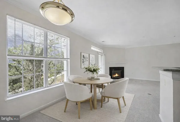 a dining room with furniture a window and a chandelier