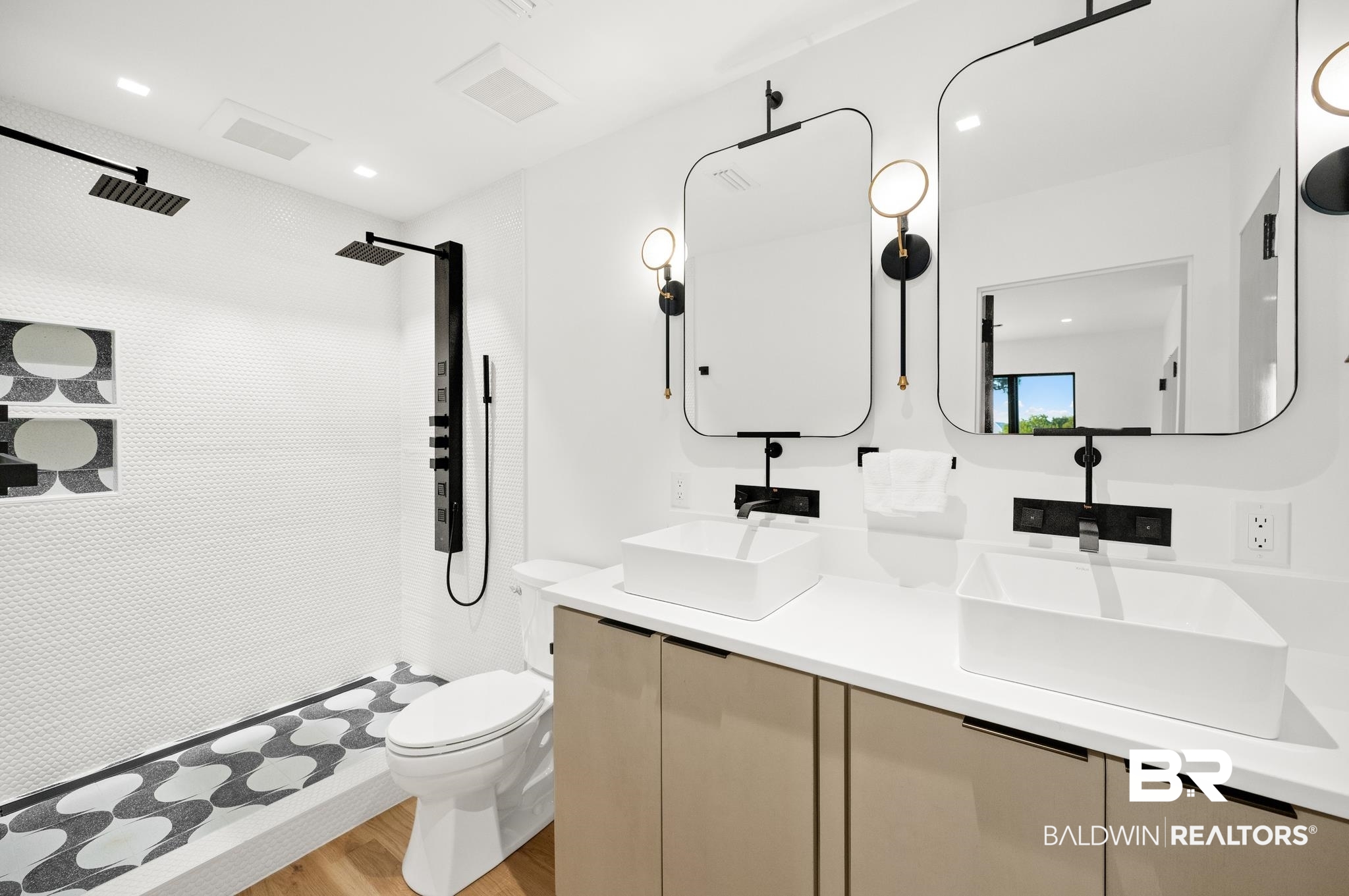 33349 River Road Orange Beach, AL 36561 - Photo 24 of 61 Dual vanity featuring rectangular vessel sinks, matte black wall-mounted faucets, and contemporary mirrors with integrated sconces