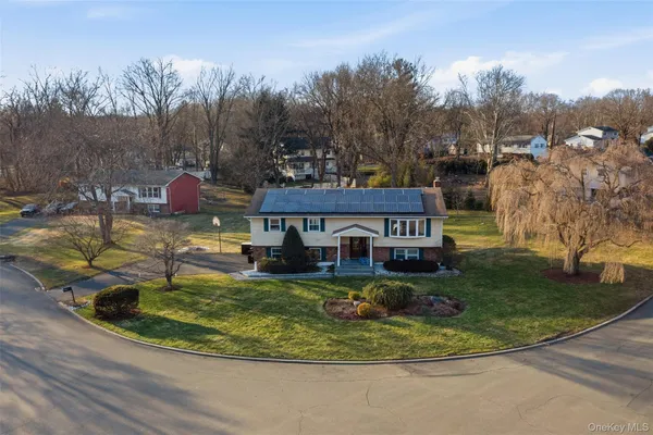 a view of a house with swimming pool and sitting area
