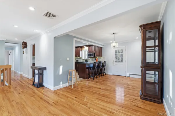 a view of a livingroom with furniture and hardwood floor