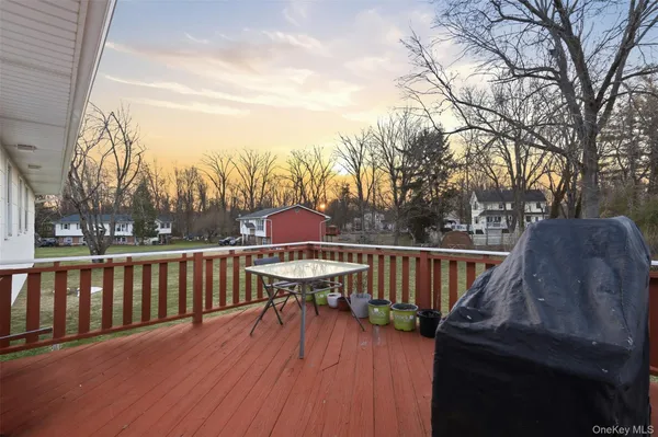 a view of balcony with wooden floor and outdoor seating