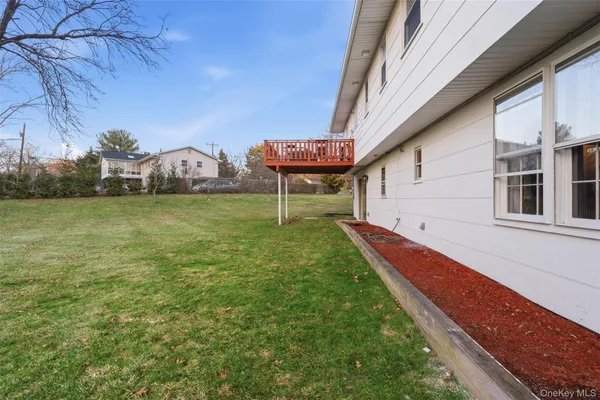 a view of a backyard with plants and a lake view