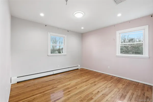 a view of a room with wooden floor and window
