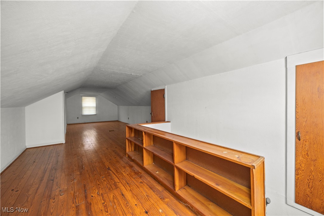 25950 Bagley Road Olmsted Falls, OH 44138 - Photo 23 of 32 Additional living space with hardwood / wood-style floors, lofted ceiling, and a textured ceiling
