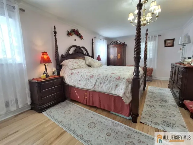 a bed room with a bed and a chandelier