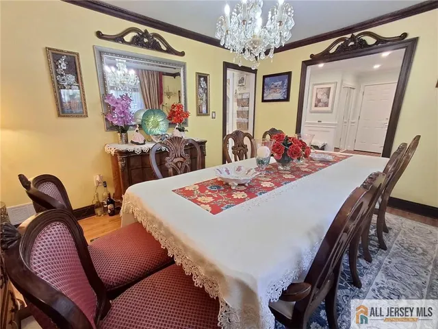a view of a dining room with furniture and chandelier