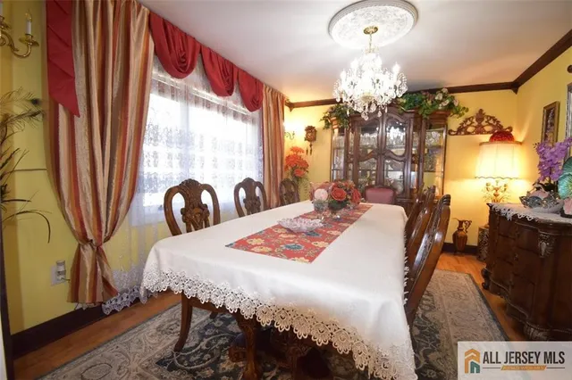 a bedroom with a bed and dresser with mirror