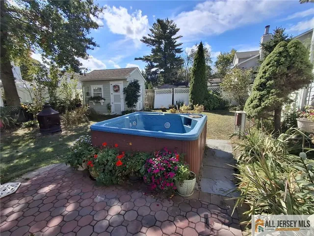 a view of a patio with couches table and chairs potted plants and large tree