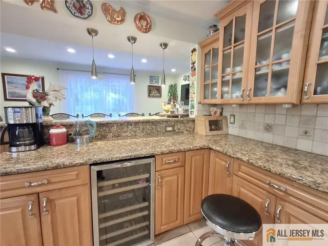 a kitchen with granite countertop a sink a stove and cabinets