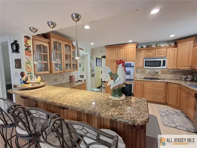 a kitchen with microwave a stove and refrigerator